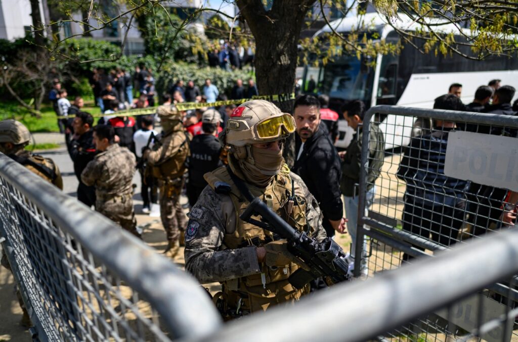 A police official stands alert near the Israeli consulate in Istanbul following a shootout between gunmen and police [AFP]