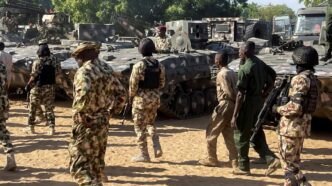 Nigerian soldiers walk past military tanks in Maiduguri, Borno State, Nigeria on November 7, 2025 [File: Ahmed Kingimi/Reuters]