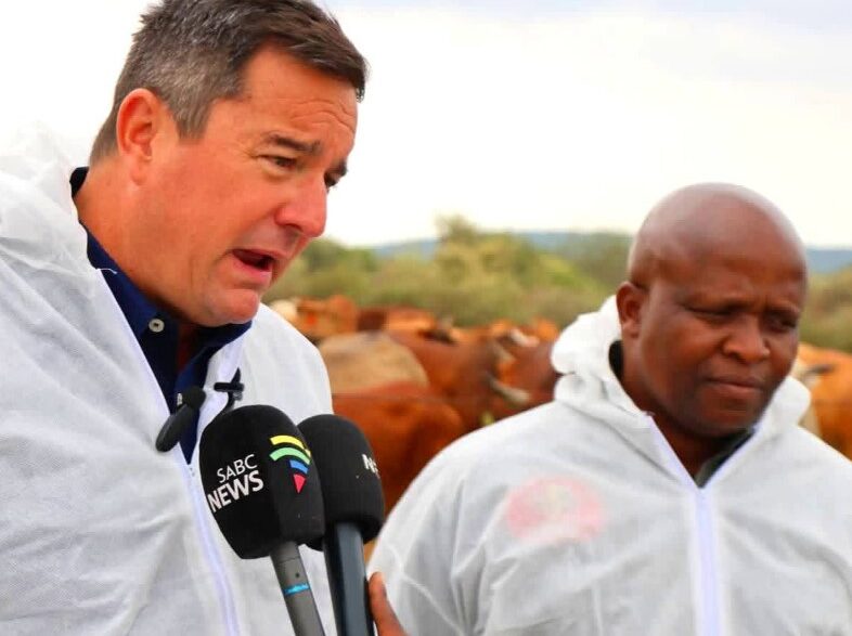 South African Minister of Agriculture John Steenhuisen addresses farmers, veterinary officials and community leaders during a joint foot-and-mouth disease vaccination and awareness drive along the Trans Kalahari Corridor at Swartkopfontein