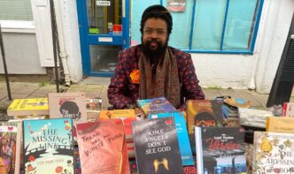 Nigerian author and filmmaker Onyeka Nwelue pictured with some of his more than 40 published books