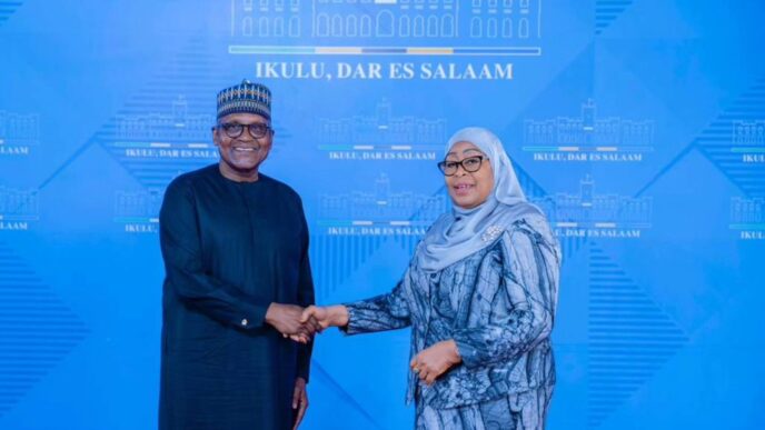 Tanzanian President Samia Suluhu Hassan and Dangote Industries Limited President and CEO Aliko Dangote shake hands during high-level discussions on industrialisation, regional energy infrastructure, and long-term economic development across Africa.