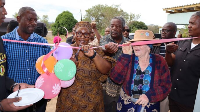 Deputy Prime Minister Thulisile Dladla cuts the ribbon during the official opening of one of the two newly built Neighbourhood Care Points handed over to communities under Mayiwane Inkhundla on Wednesday.
