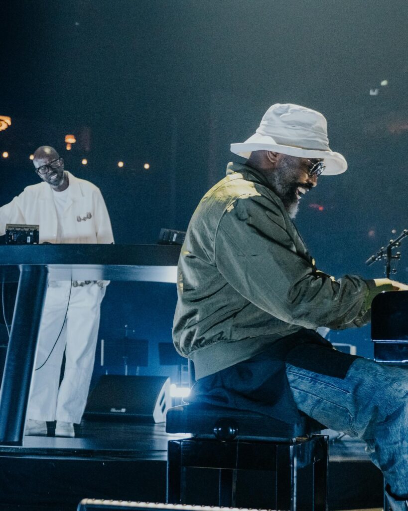 Black Coffee and South African jazz pianist Nduduzo Makhathini share a moment at the O2 Arena in London on May 22, 2026, during Black Coffee's landmark Afropolitan House orchestral show.