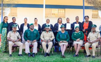 Graduates and officials pose for a group photo during the Basic Computer Skills graduation ceremony for women inmates from Mawelawela Correctional Centre, held at Southern Africa Nazarene University (SANU) in Manzini. Photo by HMCS