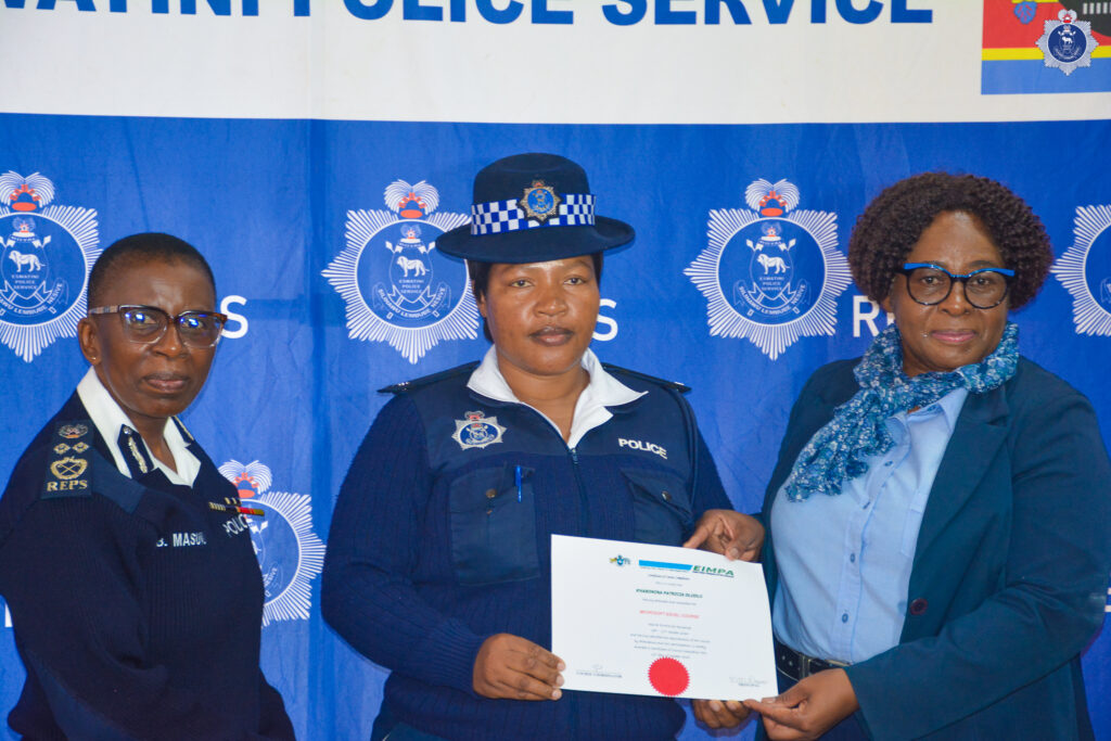 A Royal Eswatini Police Service officer receives a certificate of completion from Deputy National Commissioner of Police Ms. Bonsile Masuku during the closing ceremony of the Quality Service Delivery, Customer Care and Records Management training courses. Photo by REPS