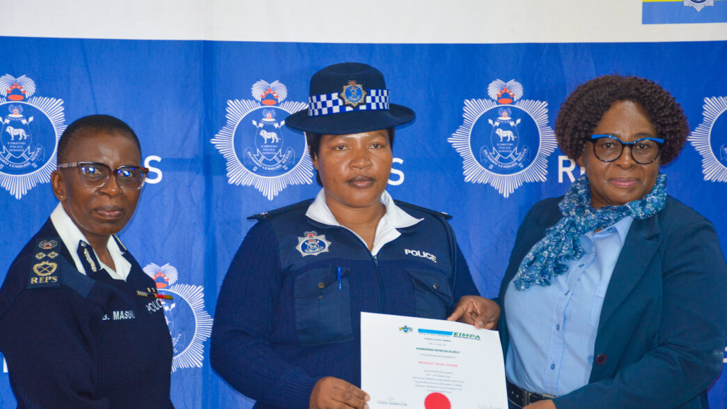 A Royal Eswatini Police Service officer receives a certificate of completion from Deputy National Commissioner of Police Ms. Bonsile Masuku during the closing ceremony of the Quality Service Delivery, Customer Care and Records Management training courses. Photo by REPS