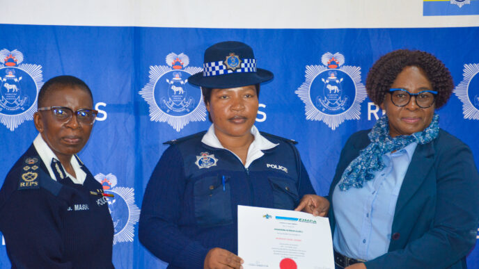 A Royal Eswatini Police Service officer receives a certificate of completion from Deputy National Commissioner of Police Ms. Bonsile Masuku during the closing ceremony of the Quality Service Delivery, Customer Care and Records Management training courses. Photo by REPS