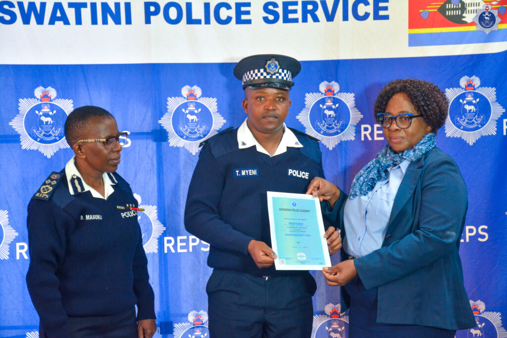 A Royal Eswatini Police Service officer receives a certificate of completion from Deputy National Commissioner of Police Ms. Bonsile Masuku during the closing ceremony of the Quality Service Delivery, Customer Care and Records Management training courses. Photo by REPS