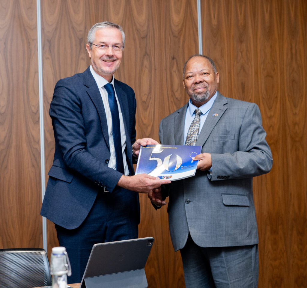 EU Ambassador H.E. Karsten Mecklenburg presents a commemorative booklet marking 50 years of EU partnership to Minister of Economic Planning and Development Dr. Tambo Gina during the 3rd Eswatini-EU Partnership Dialogue in Mbabane. Photo by Phindokuhle Sithole/Lokuhle Media