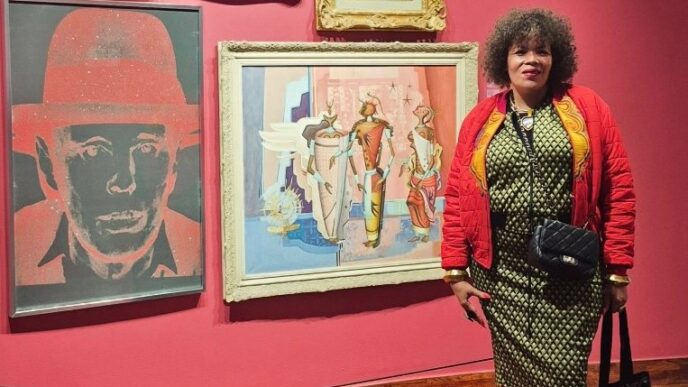 Photo: Maria McCloy pictured at a gallery, exuding the style and cultural flair she was celebrated for throughout her career. | Photo credit: Facebook