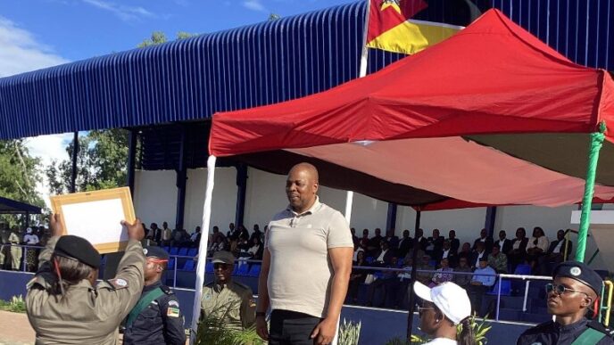 Royal Eswatini Police Service National Commissioner Manoma Vusie Masango presents appreciation certificates to Mozambican police officers for excellence across various fields during Mozambique's National Police Day celebrations at the Police Recruit Training School in Matalana.