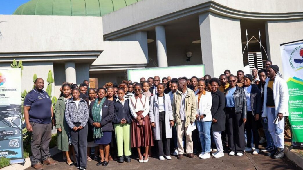 ENTC Chief Executive Officer Thulani Methula, Acting Principal Secretary for the Ministry of Tourism and Environmental Affairs Dudu Nhlengethwa-Masina, and youth participants pose for a group photo at the Youth Engagement Workshop held at King Sobhuza Memorial Park