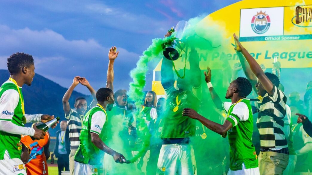 Nsingizini Hotspurs players celebrate with the trophy at Somhlolo National Stadium on Sunday, 24 May 2026, as green smoke fills the air around them