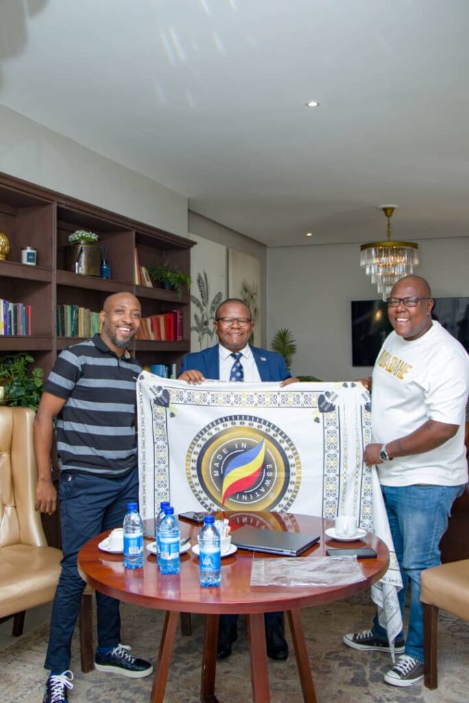 A Peculiar People chairman Melusi Zox Dlamini and Leap Taxi App director Vusani Matsebula present the Minister of Commerce, Industry and Trade with a Made in Eswatini branded Lihiya during a courtesy visit