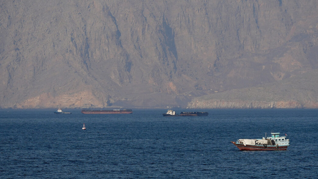 US military vessels escort commercial ships through the Strait of Hormuz on Monday