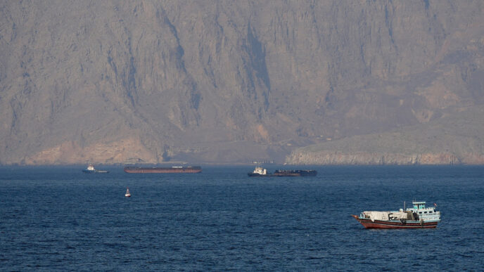 US military vessels escort commercial ships through the Strait of Hormuz on Monday