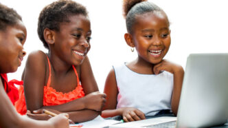 A photo of children on a computer. Photo: Gradely