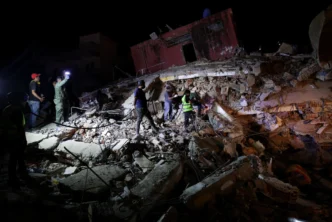 Emergency personnel work amid the rubble of a collapsed building in La Guaira on Friday. Gaby Oraa/Reuters