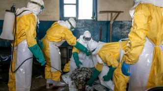 Disinfecting the body of Bahati Ibiliabo, 22, from Mongbwalu, who had gone to the hospital one day before he died. Photo by The New York Times