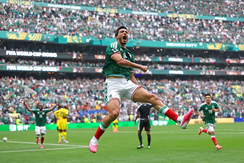 Mexico's Raúl Jiménez, celebrates his second-half goal with Gilberto Mora. Pawel Kopczynski/Reuters