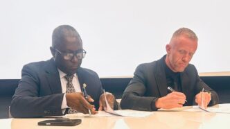 Ministry of Finance Principal Secretary, Vusie Dlamini, and Emergence Human Capital managing director, Raun Smythe, sign the agreement papers. Photos by Ministry of Finance