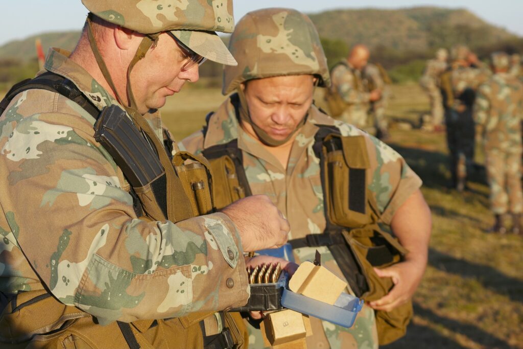A South African Army Major and Rifleman carefully prepare their ammunition and equipment during the final evaluation day's proceedings.