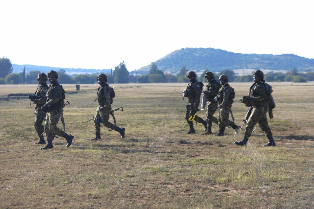 Cheerful competitors from Botswana shift to the next firing point further up the General De Wet Classification Shooting Range. Photo by SANDF