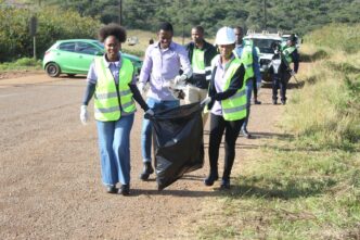 Community members, Siteki Town Council officials and representatives from participating organisations collect litter along the entrance points of Siteki Town during a World Environment Day clean-up campaign. (Photo: Siteki Town Council)