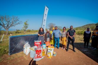 Inyatsi Foundation representatives pose with Gogo Manoma Langwenya and her family after donating food parcels and sleeping sponge to the household in Matsanjeni South. Photo: Inyatsi Foundation
