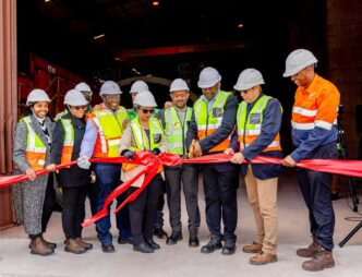 Transnet board members, executives, government representatives, industry stakeholders and project partners gather at the Saldanha Iron Ore Terminal to mark the start of testing and commissioning of the new tippler, a key milestone in a R4 billion expansion project at Africa's largest iron ore export facility. (Photo: Transnet)