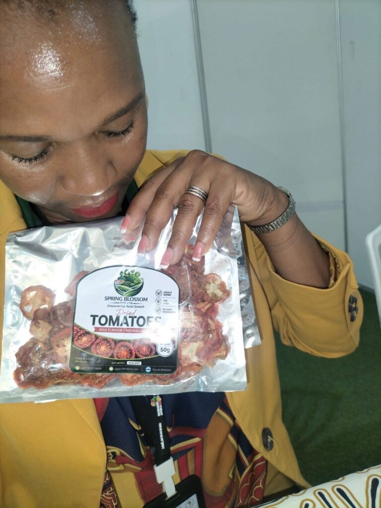 Kemo Begani displays her dried tomato products, part of a product line that was recently showcased at a UN Women South-South Exhibition. The range is among several innovations that earned her the 2025 Women in Tech Innovation Award.