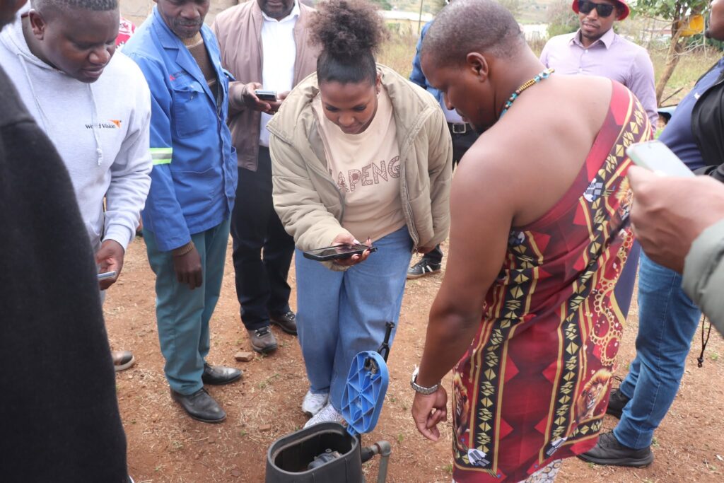 A member of the Lesotho delegation inspects a water metre at a homestead in Zandondo, where residents now access clean, piped water through the SZL 14.4 million water scheme. Picture: World Vision Eswatini
