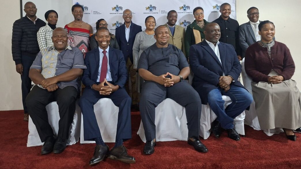 Minister of Labour and Social Security Phila Buthelezi takes pictures with the scholarshi section board.