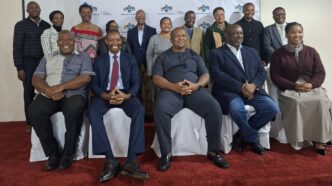 Minister of Labour and Social Security Phila Buthelezi takes pictures with the scholarshi section board.