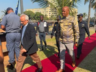Got it! Here are the corrected captions: Acting Minister of Police Firoz Cachalia and KwaZulu-Natal Premier Thami Ntuli at the June 30 operational deployment parade in Durban on Sunday.