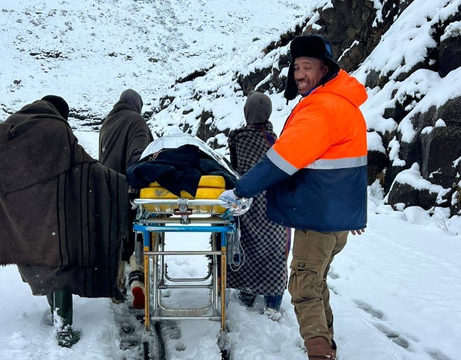 Clifford Tar, known as "Mr Lifesaver," alongside the three shepherds who helped him carry a critically ill pregnant woman on a stretcher through snow at Moteng Pass during Thursday's dramatic rescue operation. | Photo: LENA