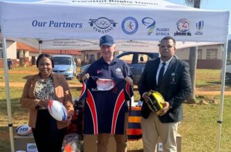 British High Commissioner Colin Wells poses with Eswatini Rugby Union and SKRUM representatives alongside some of the 26 boxes of rugby kit donated by UK NGO SOS Kit Aid to grow the game of rugby in the Kingdom. (Photo: British High Commission in Eswatini)