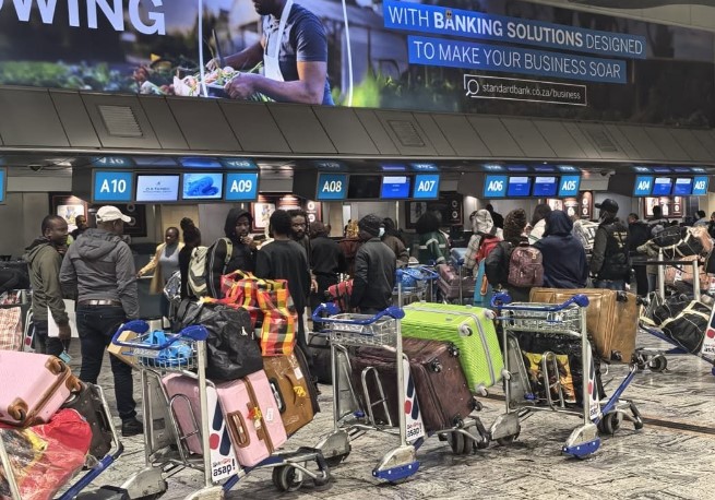 Ghanaian nationals queue at the check-in and immigration processing area at OR Tambo International Airport on Sunday ahead of their repatriation flight to Ghana, arranged by the Ghanaian High Commission in Pretoria. (Photo: Border Management Authority)