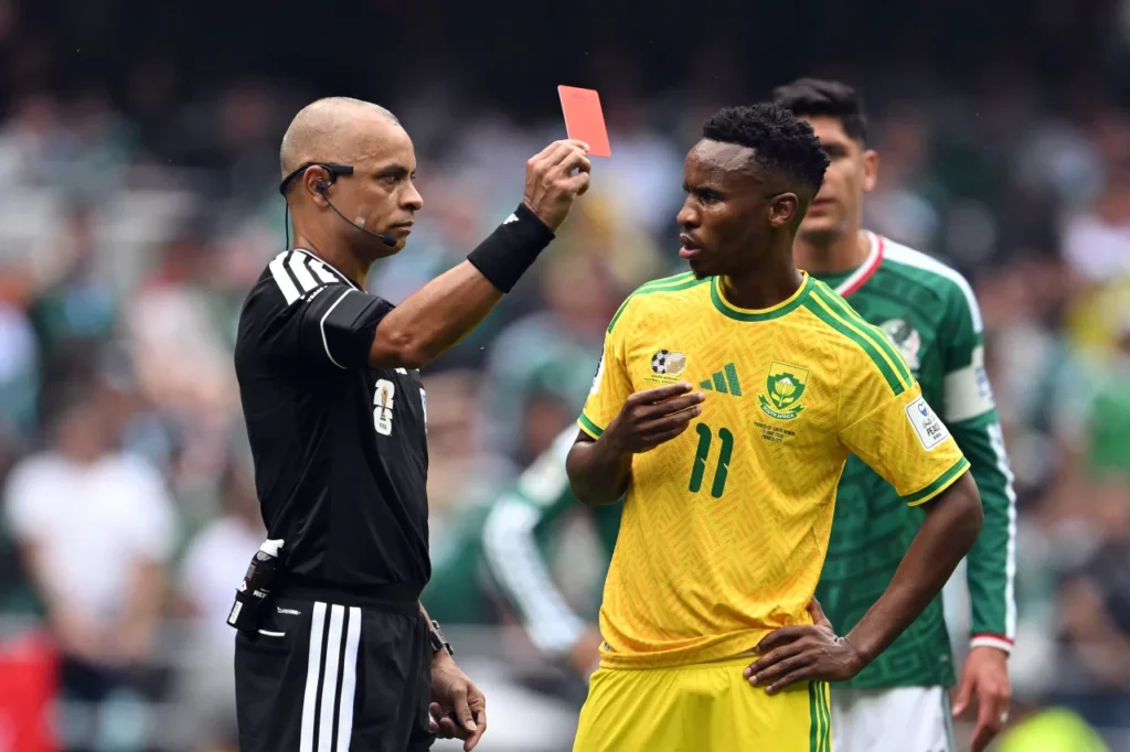 Referee Wilton Sampaio shows a red card to South Africa's Themba Zwane after a VAR check in the second half. Yuri Cortez/AFP/Getty Images