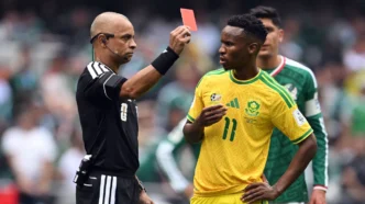 Referee Wilton Sampaio shows a red card to South Africa's Themba Zwane after a VAR check in the second half. Yuri Cortez/AFP/Getty Images