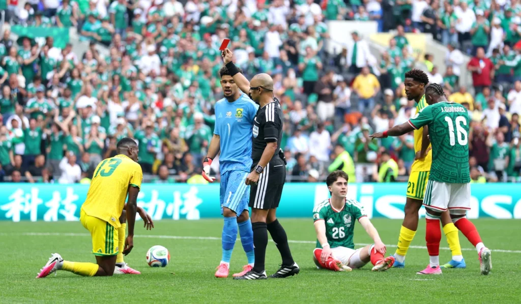 Referee Wilton Sampaio issues a red card to South Africa's Sphephelo Sithole early in the second half. Carl Recine/Getty Images