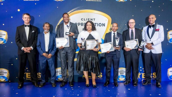 Eswatini Revenue Service Tax Commissioner and Minister of Finance, Neal Rijkenberg, pose with award recipients during the 2024 Client Appreciation Day group photo.