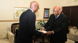 His Majesty King Letsie III presents the instruments of appointment to Ambassador Designate Molefi Christopher Nyaka.