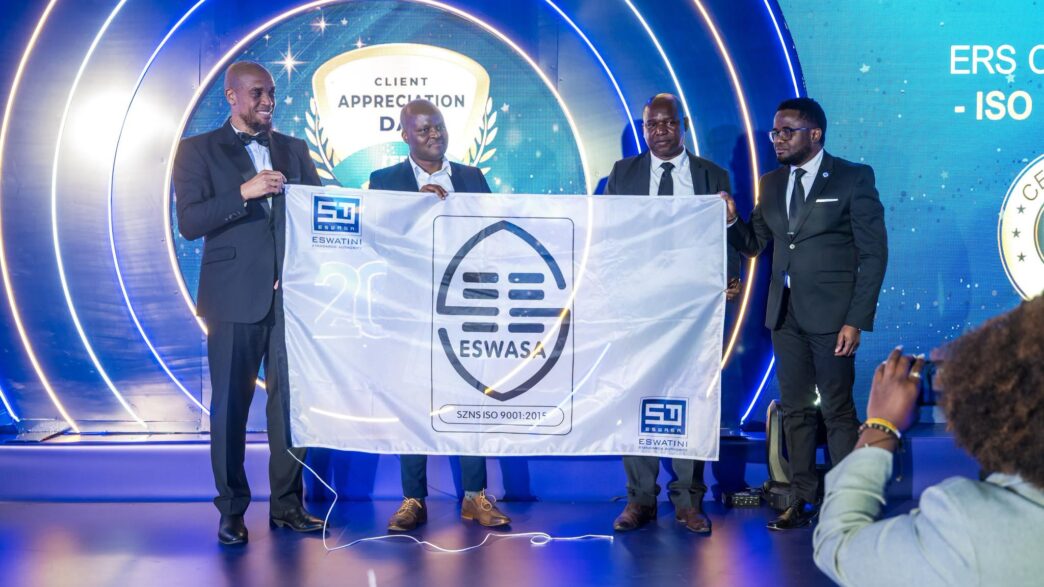 Eswatini Revenue Service Commissioner General Brightwell Nkambule receives the ISO 9001 certification flag from the ESWASA Director during a handover ceremony. (Photo: Eswatini Revenue Service)