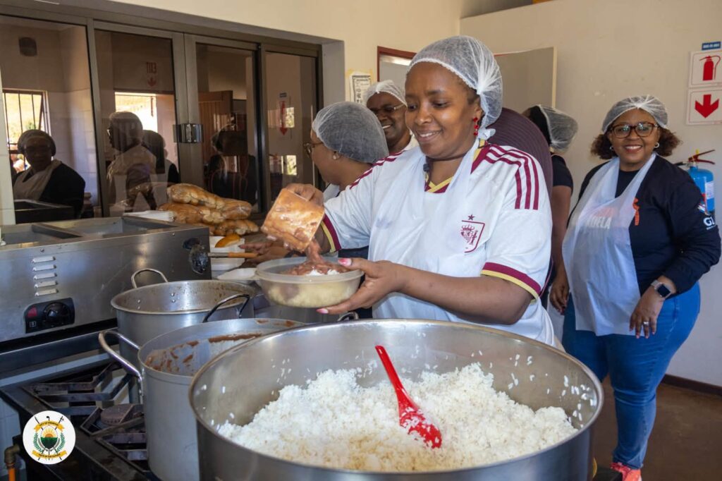 One of the volunteers dishes out food to those gathered at the Sidwashini Social Centre during the 67 minutes of service. Photo by Municipal Council of Mbabane