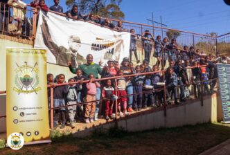 Mbabane City Mayor Mr. Thulani Mkhonto and Chief Executive Officer Ms. Gciniwe Fakudze pose for a group photo with some of the children they served meals to at the Sidwashini Social Centre. Photo by Municipal Council of Mbabane