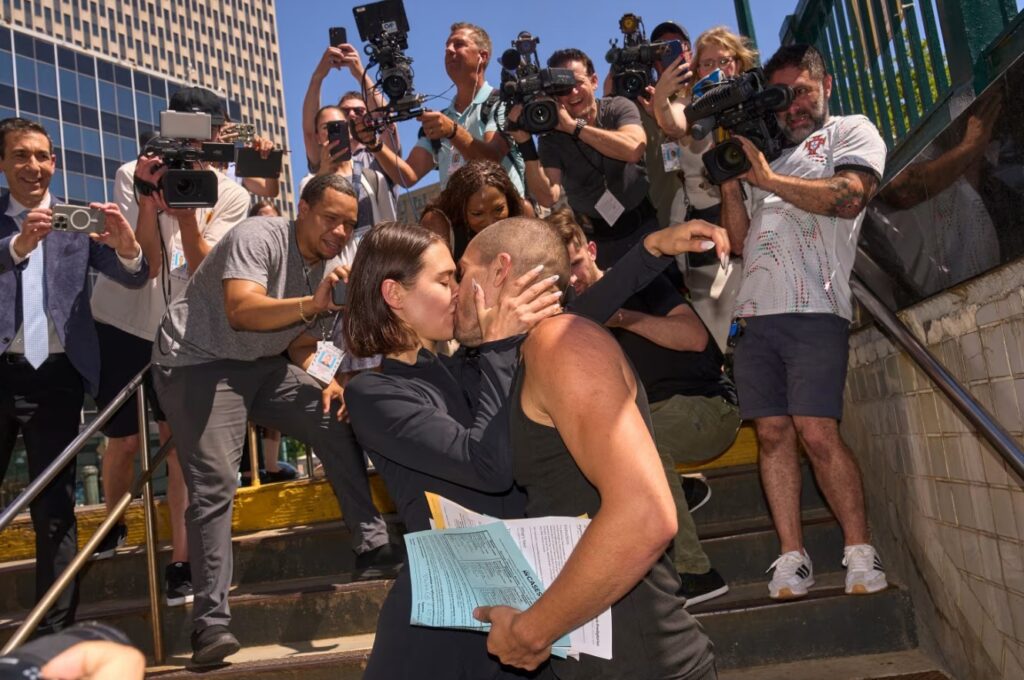 Extreme climbers Angelina Nikolau and Ivan Kuznetsov kiss at the Brooklyn Bridge-City Hall subway station after their arraignment on Thursday. Bing Guan/Reuters