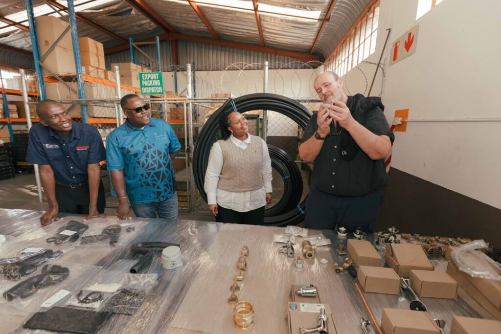 Her Royal Highness Princess Sakhizwe examines locally blown glassware during her visit to Ngwenya Glass, where she engaged artisans on their craft and production process. Photo credit: A Peculiar People