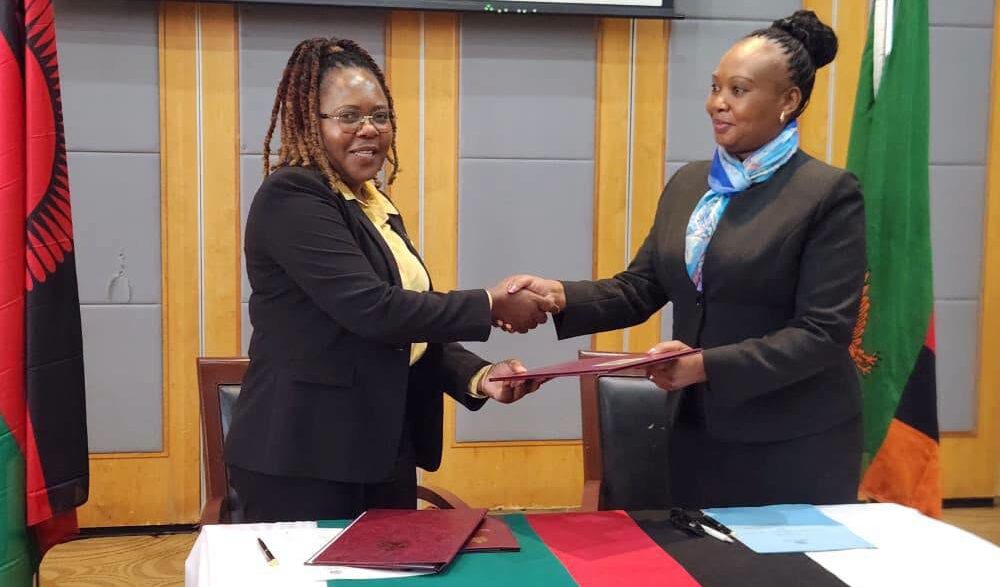 Exchanging the MoU documents: Officials from Zambia and Malawi exchange copies of the reviewed 2018 Memorandum of Understanding on Tourism Cooperation during the closing ceremony in Lilongwe. Photo by Ministry of Tourism Zambia.