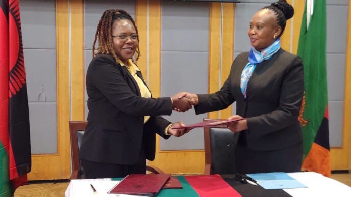 Exchanging the MoU documents: Officials from Zambia and Malawi exchange copies of the reviewed 2018 Memorandum of Understanding on Tourism Cooperation during the closing ceremony in Lilongwe. Photo by Ministry of Tourism Zambia.